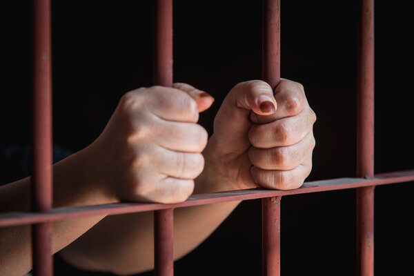 Woman hand in jail