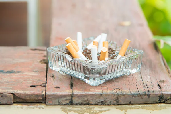 Ash tray on wooden plank