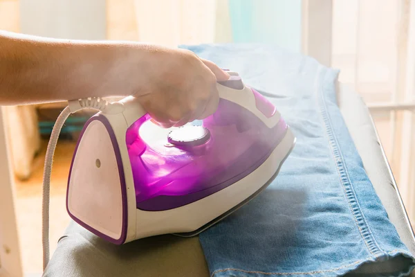 Steam iron on board — Stock Photo, Image