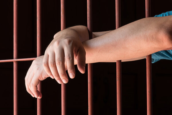 Woman hand in jail