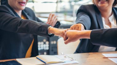 Group of diversity people fist bump holding hands together power of tag team. Teamwork Multiethnic people group working togetherness. Business people team holding hands successful. Business meeting clipart