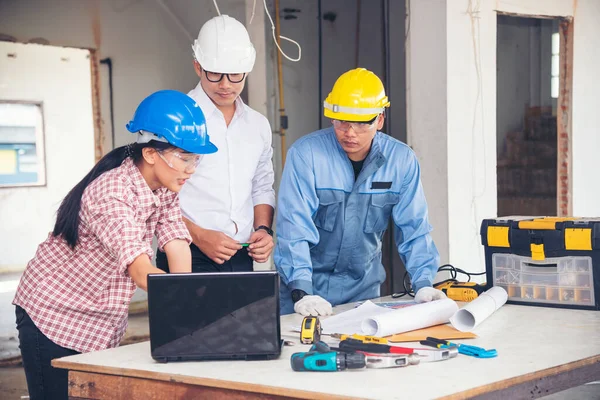 Construction engineer teamwork Safety Suit Trust Team Holding White Yellow Safety hard hat Security Equipment on Construction Site. Hardhat Protect Head for Civil Construction Engineer Concept