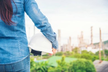 Kadın mühendis, inşaat işçisi. Rafineri petrol fabrikasında çalışan kadın mühendis. Genç inşaat mühendisi, başlık kaskı inşaat alanında takıyor..