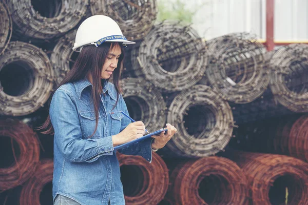 Woman construction engineer wear safety white hard hat at construction site industry worker. Female engineer worker civil engineering with hard hat safety helmet. Woman construction Engineer concept