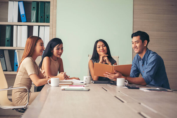 Happiness diversity business team meeting corporate office desk in company meeting room. Asian team group partner brainstorming discussion multiethnic people sitting share ideas teamwork in boardroom