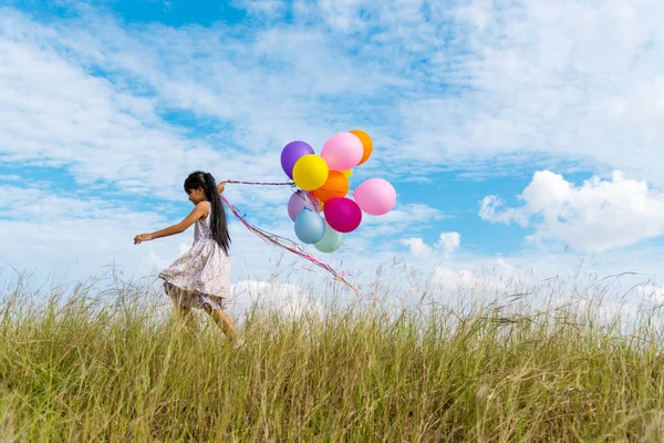 Cheerful Cute Girl Holding Balloons Running Green Meadow White Cloud — Stock Photo, Image