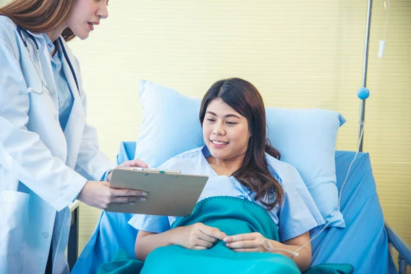 Woman doctor and patient consultation with professional specialist diagnostics at hospital medicare treatment clinic. Doctor writing prescription for medical health care therapy.