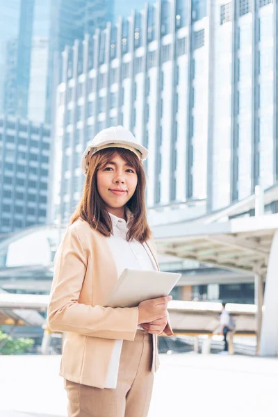 Woman construction engineer wear safety white hard hat at construction site industry worker. Female engineer worker civil engineering with hard hat safety helmet. Woman construction Engineer concept