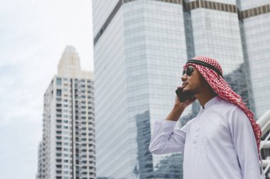 Akıllı telefon uygulaması kullanan İslami adam, ajandasını akıllı telefon Müslüman modern uae şehrine odaklıyor. Arap erkekleri tesettür ve Müslüman resmi giysileri giyer. Çevrimiçi yaşam tarzı mesajları gönderir.