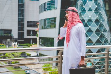 Akıllı telefon uygulaması kullanan İslami adam, ajandasını akıllı telefon Müslüman modern uae şehrine odaklıyor. Arap erkekleri tesettür ve Müslüman resmi giysileri giyer. Çevrimiçi yaşam tarzı mesajları gönderir.