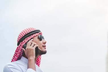 Akıllı telefon uygulaması kullanan İslami adam, ajandasını akıllı telefon Müslüman modern uae şehrine odaklıyor. Arap erkekleri tesettür ve Müslüman resmi giysileri giyer. Çevrimiçi yaşam tarzı mesajları gönderir.
