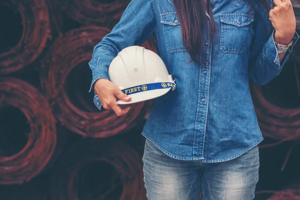 Woman construction engineer wear safety white hard hat at construction site industry worker. Female engineer worker civil engineering with hard hat safety helmet. Woman construction Engineer concept