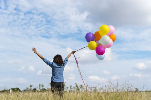 Woman Holding Balloons Running Green Meadow White Cloud Blue Sky — Stock Photo, Image