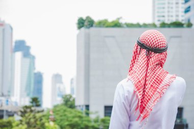 İslamcı adam modern uae şehrinde resmi Müslüman elbisesi giyer. Arap erkekleri geleneksel türban başörtüsü Müslüman yaşam tarzı. Arap Suudi Arabistan Kültürü. Çeşitlilik Arabistan Erkekleri ayakta