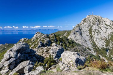 Işıl ışıl deniz manzarası, yemyeşil yeşil arazi, kayalık kıyı şeritleri, berrak mavi sular ve seyahat ve doğa fotoğrafçılığı için mükemmel doğal güzellik Elba Adası 'nın nefes kesici manzarası.