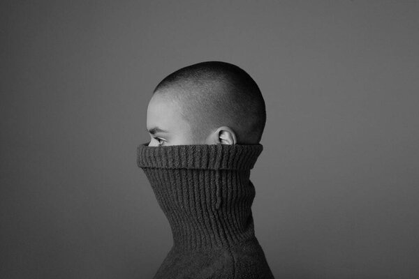 Portrait of a beautiful and bald woman looking aside. Black and white shot.