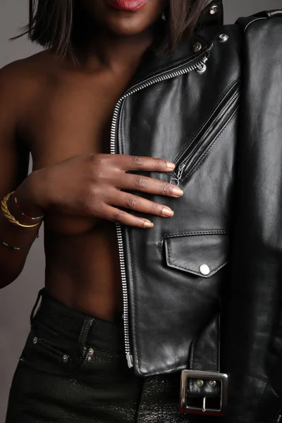 Beautiful stylish young black woman wearing black leather jacket.