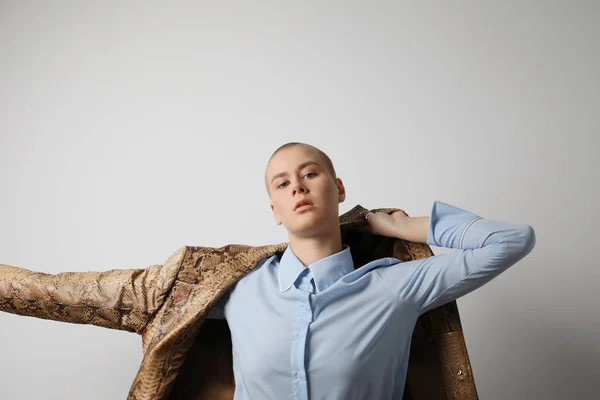Мода лисий жінка позує в студії, прикидаючись носить бежевий піджак . — стокове фото