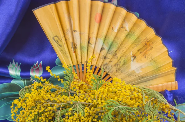 Csokor, mimóza és a kínai kézi ventilátor kék selyem — Stock Fotó