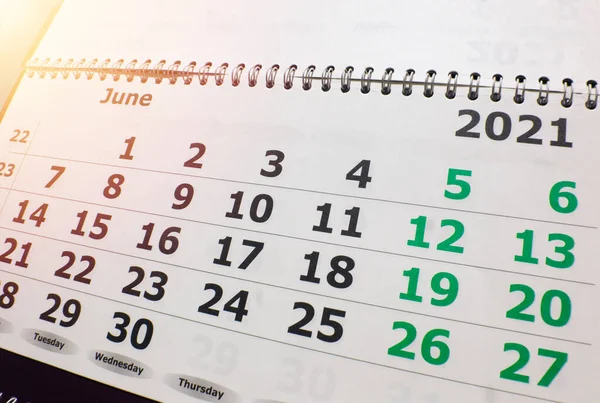Calendar for the month of June 2021, wall calendar with a spiral on the background of sunlight, light up.