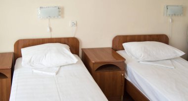 İki boş SINGLE yatak ve komodinli otel odası, otel işi konsepti.