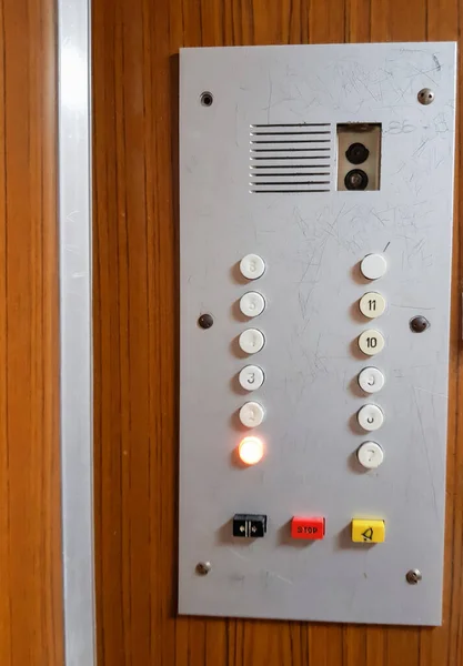 Close-up of the button panel in the old elevator, vertical frame.