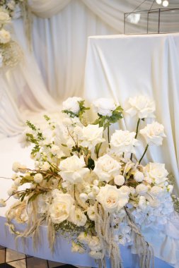 The wedding background is decorated with white and blue flowers