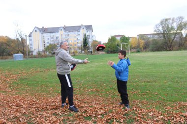 Bir adam ve bir çocuk antrenman eldivenleri üzerinde antrenman yapıyor ve pratik yapıyorlar.