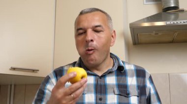 Sarı elma yiyen bir adam. Yakın plan.