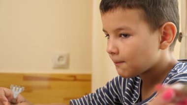 Çocuk çatalla et yiyor. Yakın plan.