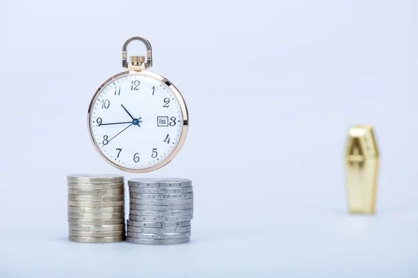 Pocket watch with European currencies and tomb — Stock Photo, Image