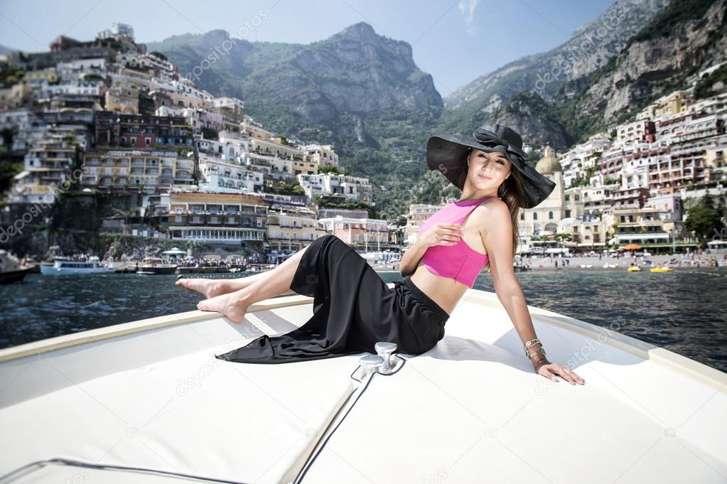 Beautiful girl in Positano on the Amalfi posing on the boat