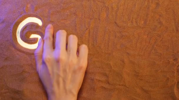 Dessin à la main Grèce symbole dans le sable. Fond de plage. Vue du dessus — Video