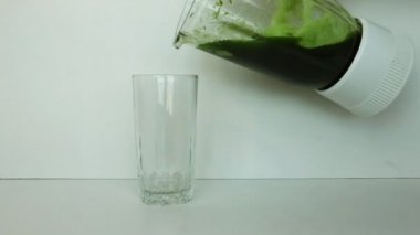 Wheat Green Seeds in blender (mixer), a Raw Food Diet. Healthy Vegetarian Food concept: Germination of Wheat at home, Growing. In Glass