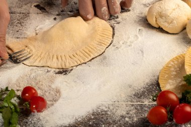 The cook prepares pasties. Step-by-step instruction. Forms the dough. Wooden background. clipart