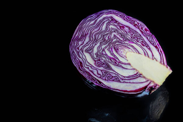Red cabbage. Raw vegetable on a black background. Foreground. Vegetarian food.