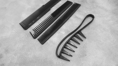 Special hairdressing scissors and comb. Professional equipment. On a gray background. Copy space