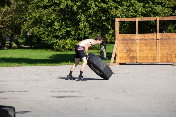 City Liepaja,Latvia.The man is lifting a heavy tire.19.09.2020
