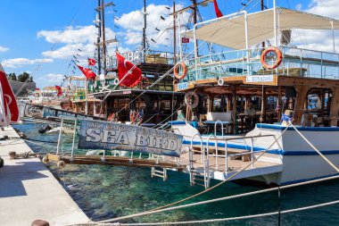 KUSADASI, TURKEY - JUNE 2, 2021: These are pleasure tourist boats docked at the pier.