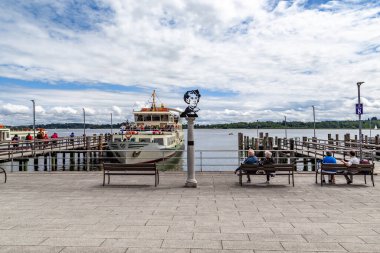 PRIEN AM CHIEMSEE, GERMANY - MAY 24, 2024: This is the city embankment and the piers with boats at Lake Chiemsee.