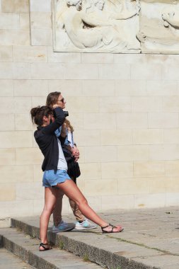 BARCELONA, SPAIN - MAY 9, 2017: Unidentified young women are keen on taking photographs of city landmarks.