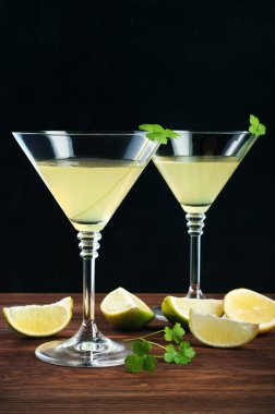 Cam şarap gözlük ile likör limoncello ahşap bir gemide. Siyah arka plan. Metin yazma için bir yer. Alkollü içecek gözlük