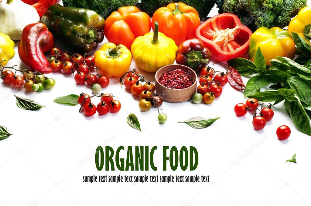 Organic food concept. Fresh juicy vegetables and herbs, such as multi-colored peppers, cherry tomatoes, squash and basil leaves on a white background. Vegetarian, vegan products. Space for text