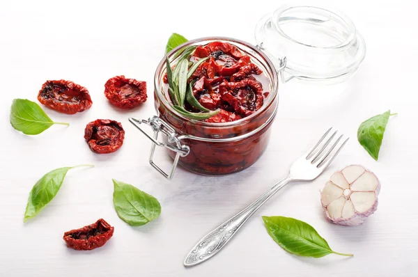 Sun-dried tomatoes in a glass jar on a white background. Vegetarian, vegan concept. Mediterranean and Italian cuisine — Stock Photo, Image