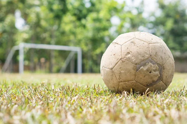 Old football, dry field and white goal — Stock Photo, Image