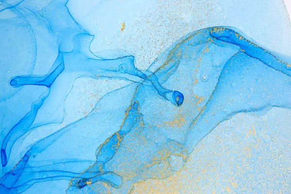 Blue and gold ink drops mixed with gold powder.