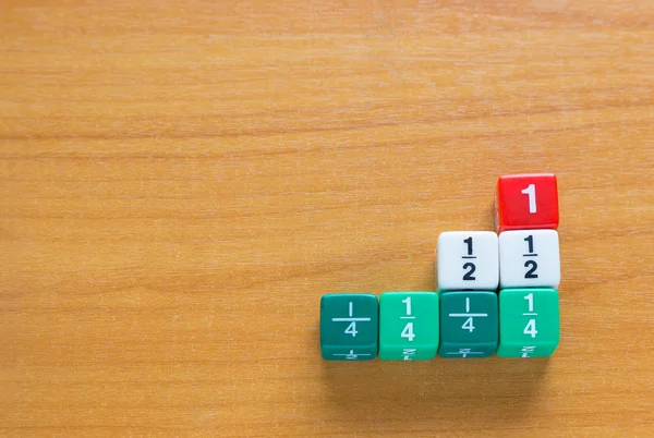 Color fraction dices on wood table — Stock Photo, Image