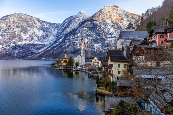 View of the famous Hallstatt town at the lake with mountain ranges in background on an evening of a spring day