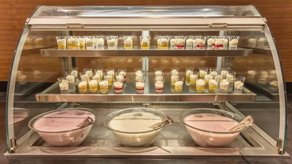 Hotels Breakfast Buffet. The regional cuisine of Israel in a hotel. Different types of fresh yogurts and desserts. Buffet etiquette Travel photo