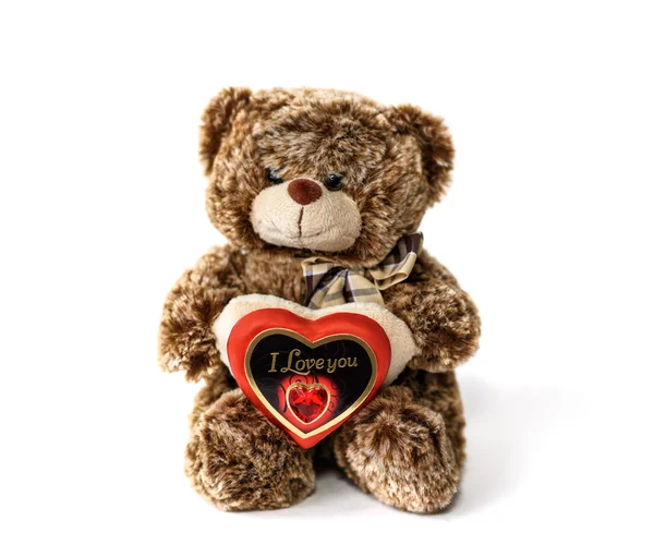 Ours en peluche mignon et coeur de chocolat rouge avec le texte "Je t'aime" sur le fond blanc — Photo